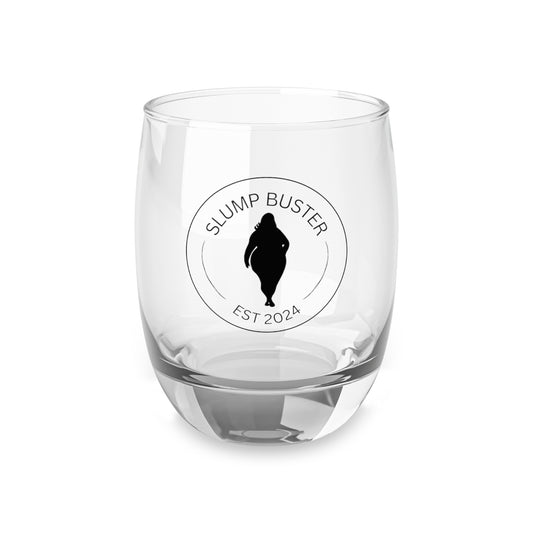 A clear whiskey glass with a modern design, featuring a round slump buster print on the side, on a white background.